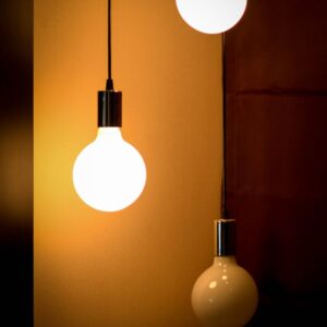 Home Composition of three glowing light bulbs creating a warm ambiance. Ideal for energy and design themes.